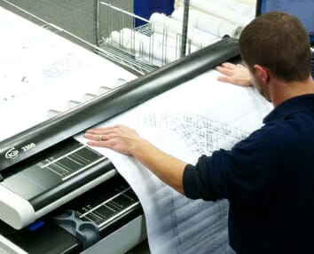 Man operating document scanning equipment