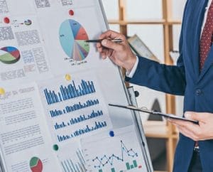 Person with pen looking over a full color infographic