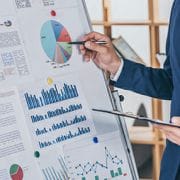 Person with pen looking over a full color infographic
