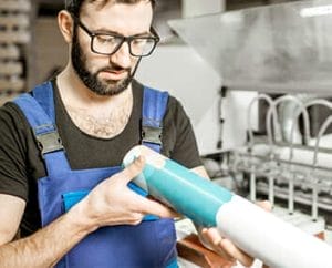 Man looking over a vinyl graphic printing.