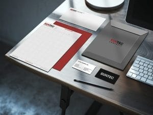 Desk showing examples of Suntec printed logos on letterhead, business cards, envelopes, etd.