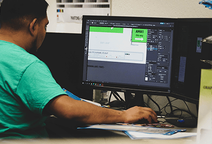 Graphic artist working at a computer in a print shop