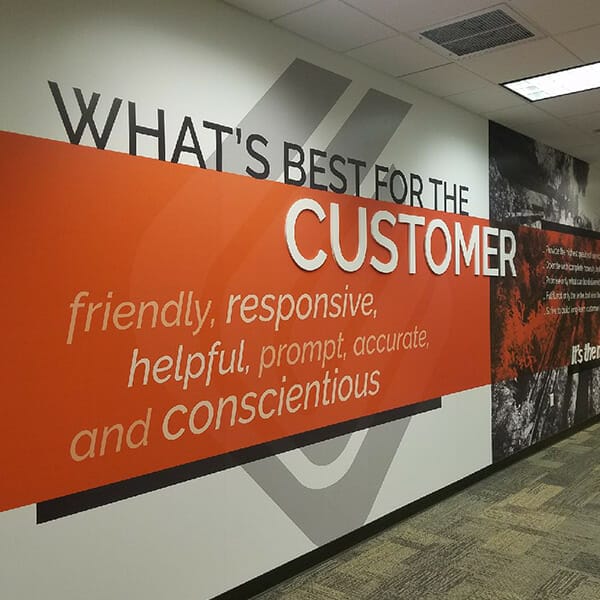 Large wall covering with the words "What's best for the customer."