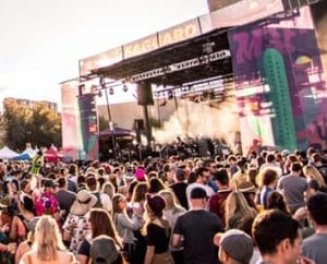 Photo of an event with a large crowd near a stage.