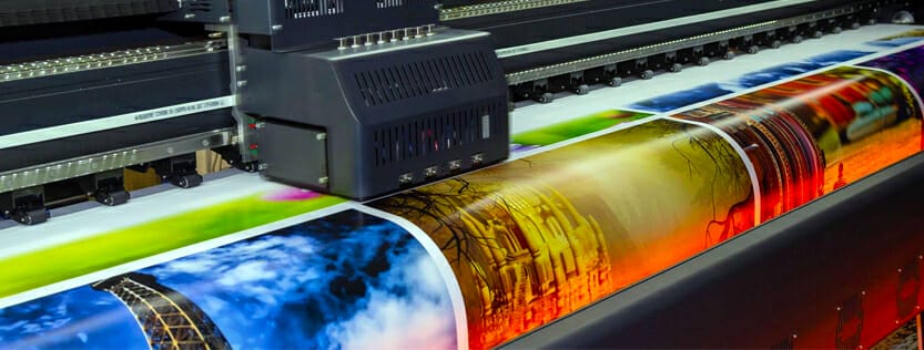 Wide format commercial printer printing color images.