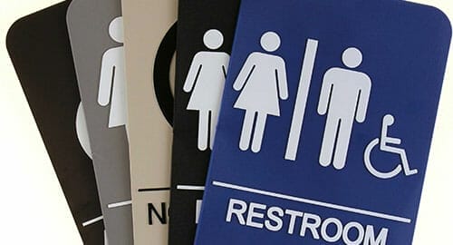 ADA bathroom signs in various colors.