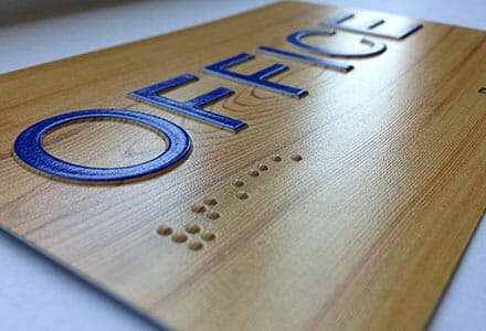 ADA office placard with braille.