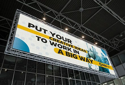 Oversized banner displayed in large warehouse.