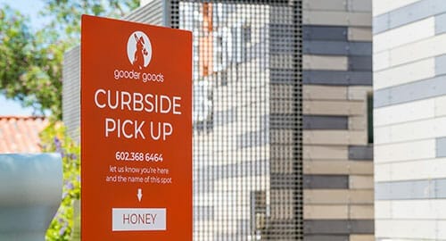Parking curbside pick up sign for Gooder Goods cafe and eatery.