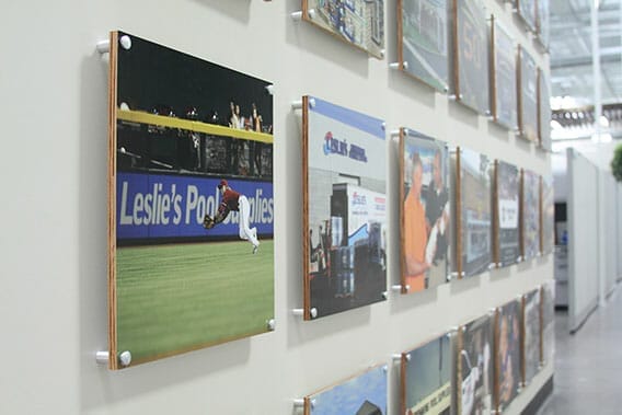 Standoff wall signs and printed photos on a large wall.