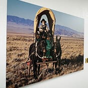 Printed posted of a stagecoach hanging on a wall.