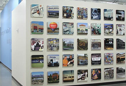 35 color photos installed to cover an interior wall.