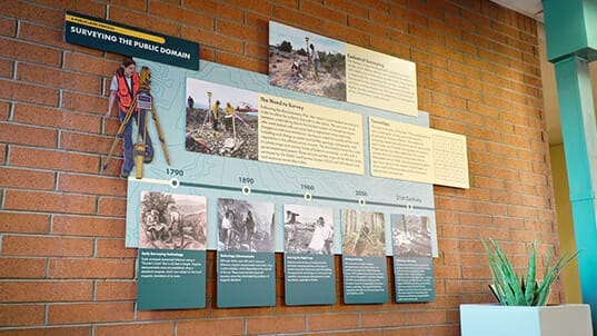 Interior brick wall with informational wall graphics installed.