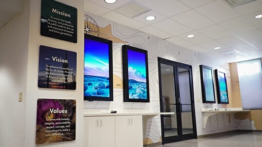 A series of full-color informational wall art on both sides of a double door.