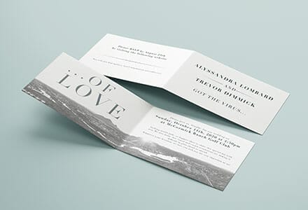 Folded wedding invitation printed in black and white.