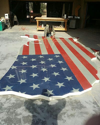 American flag printed and cut to the shape of the USA.